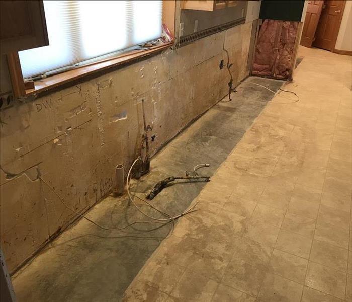 Clean wall that has had cabinets ripped out.