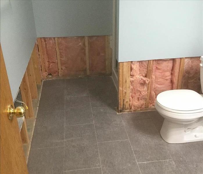 Bathroom with flood cuts exposing insulation 