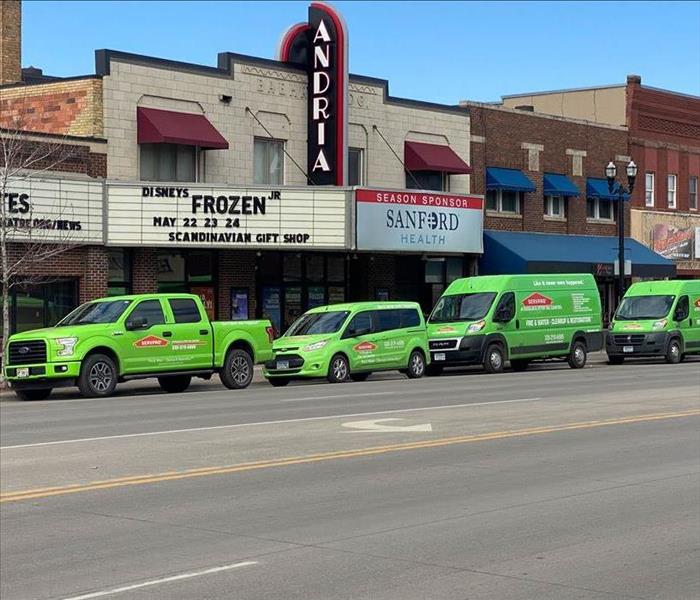 Four SERVPRO vehicles parked.